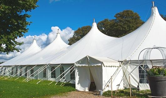 tall green portable restrooms assembled at a music festival, contributing to an organized and sanitary environment for guests in Griffith, IN